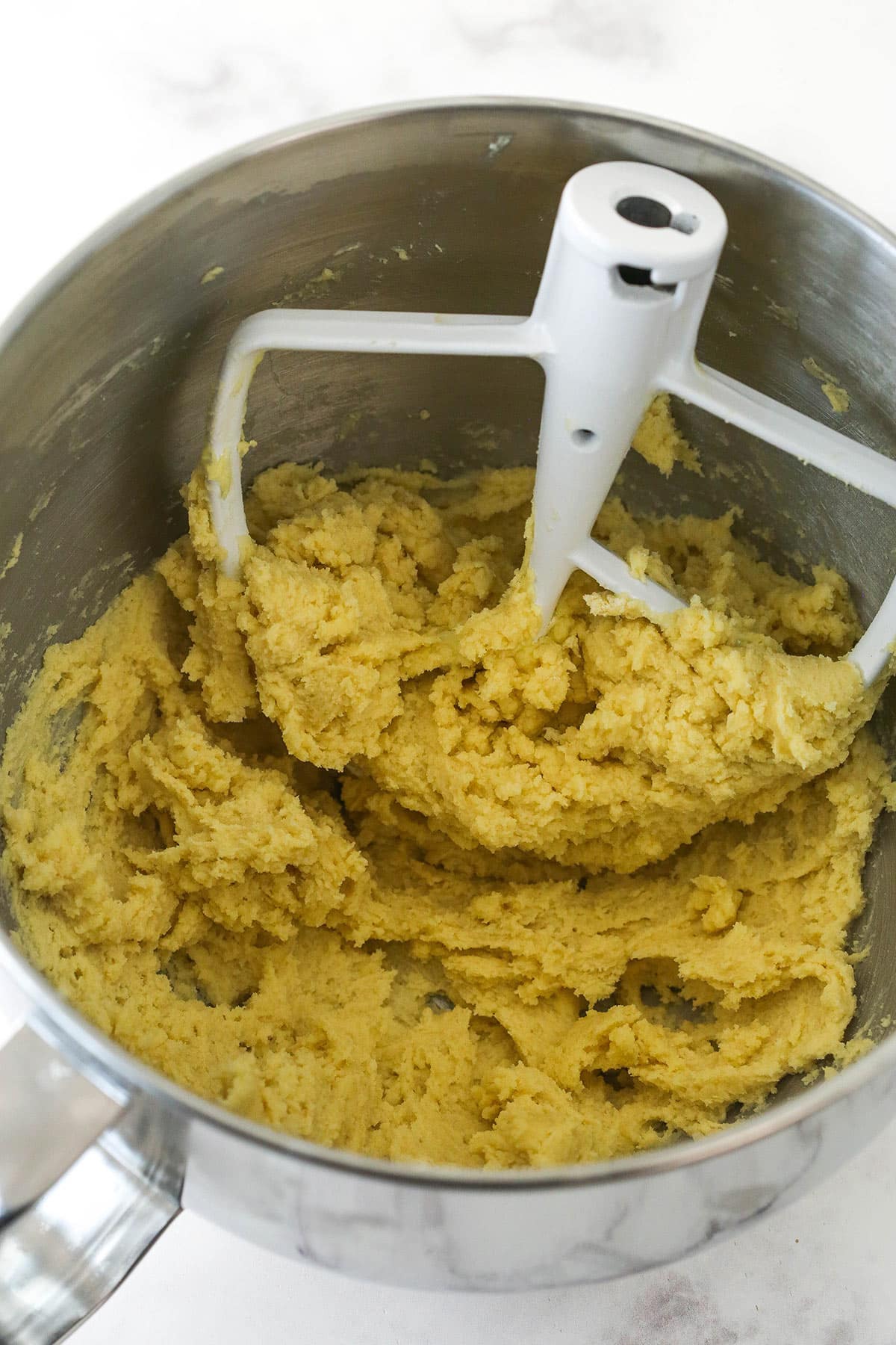 Cookie dough in a mixer bowl.