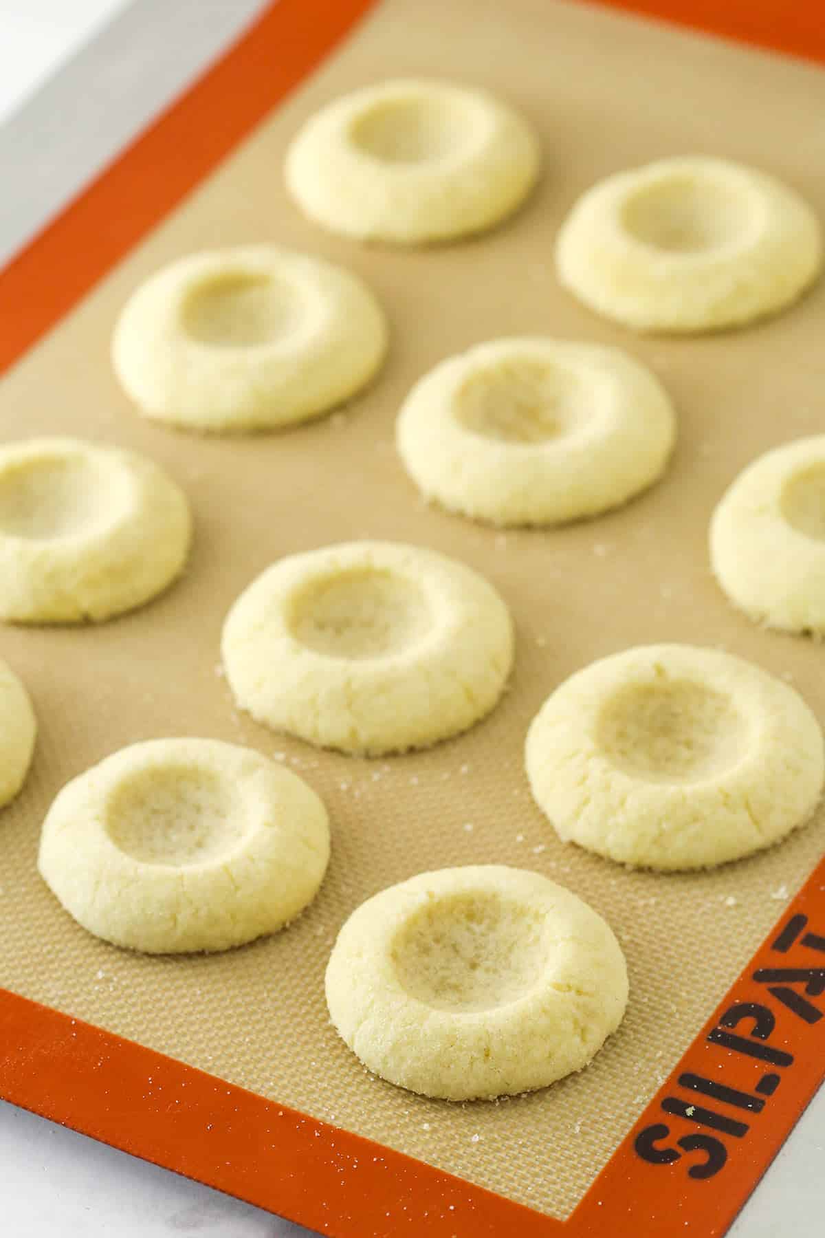 Baked cookies on the cookie sheet and silicone baking mat.