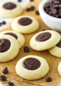 chocolate thumbprint cookies on brown parchment paper