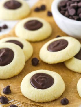 chocolate thumbprint cookies on brown parchment paper