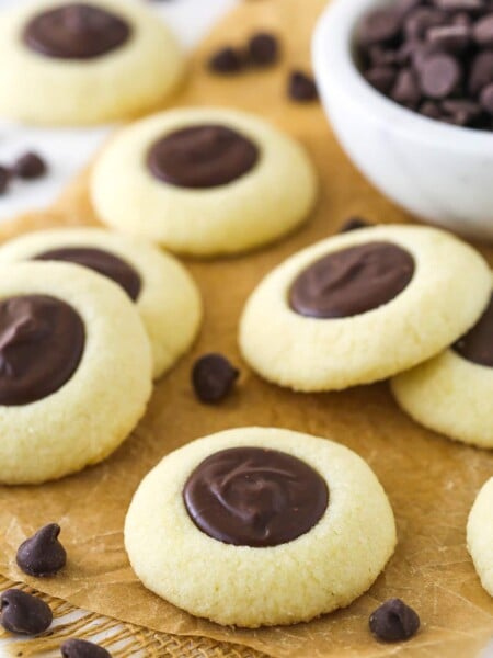 chocolate thumbprint cookies on brown parchment paper