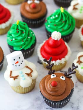 finished decorated christmas cupcakes on marble background