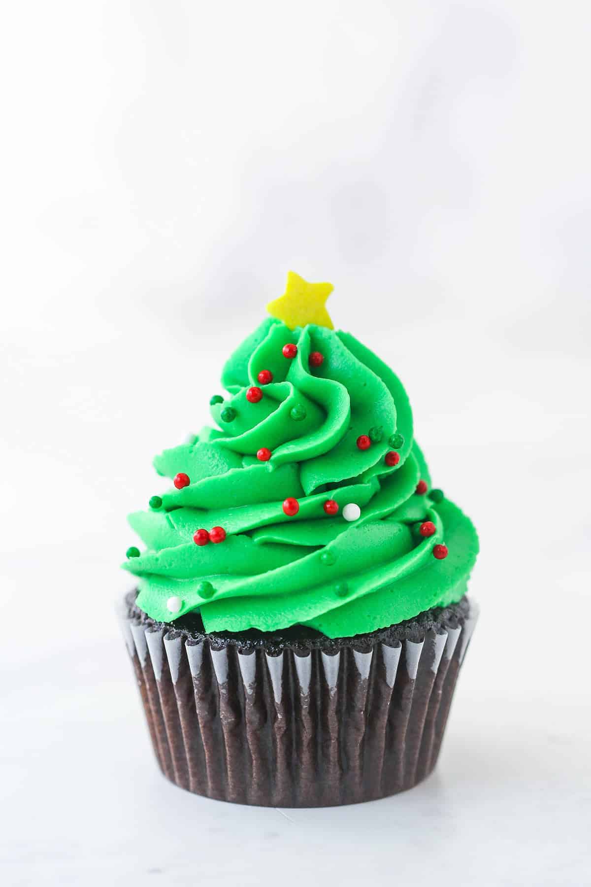 finished christmas tree cupcake with decorations added
