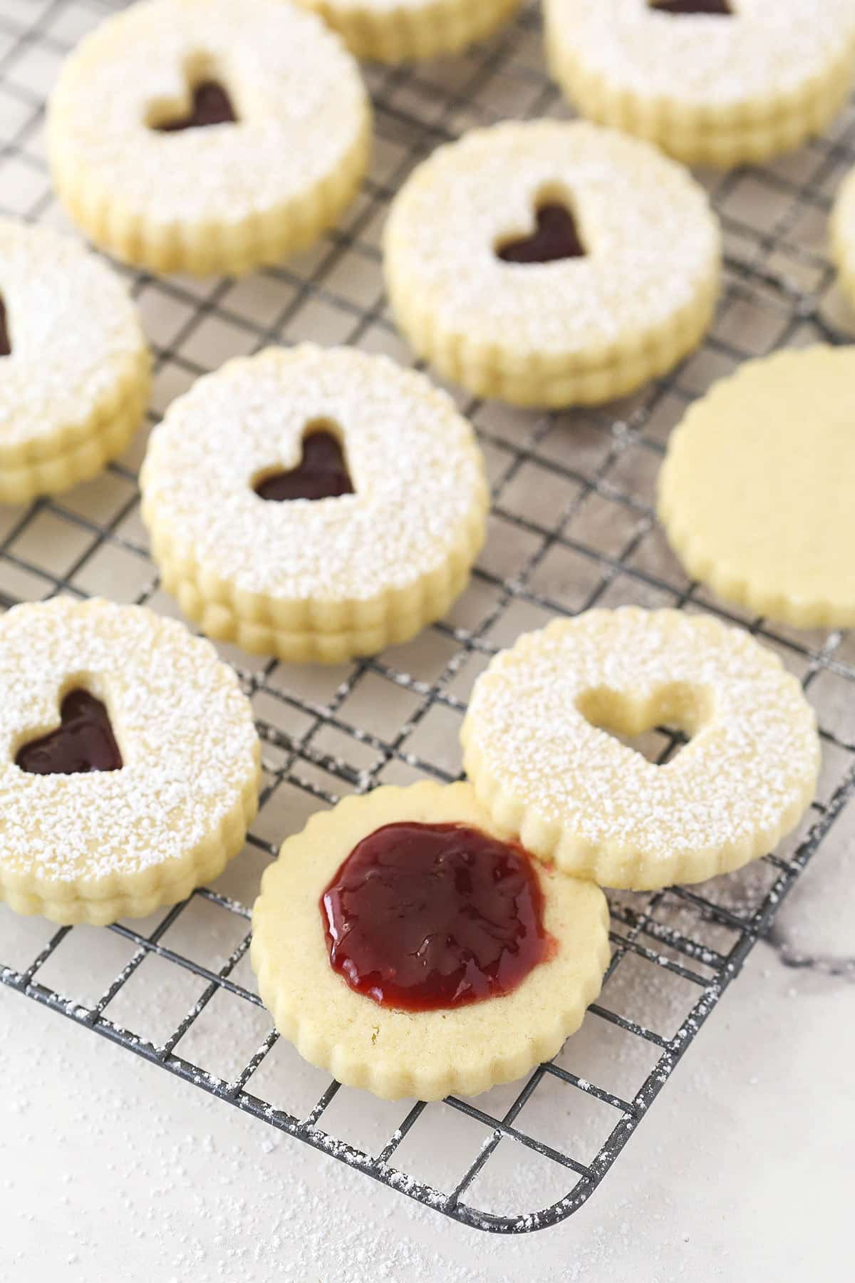 Open linzer tart cookie with filling in the center.