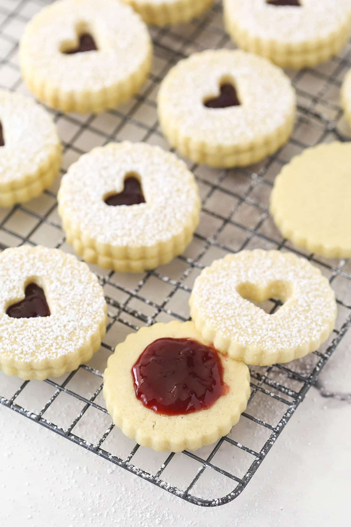Open linzer tart cookie with filling in the center.