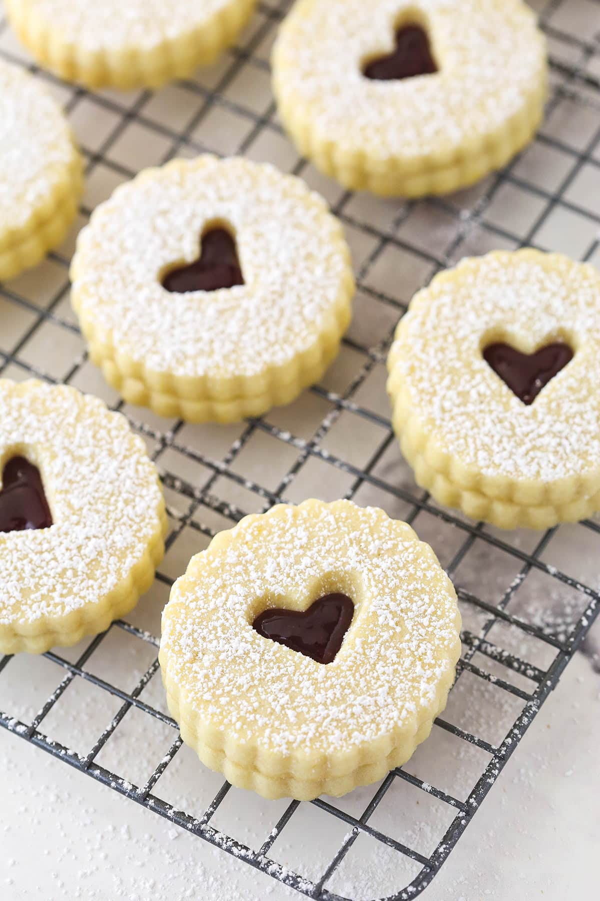 Linzer cookies on a cooling rack.