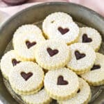 Linzer tart cookies on a plate.