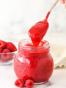 Raspberry filling for cake in a glass jar.