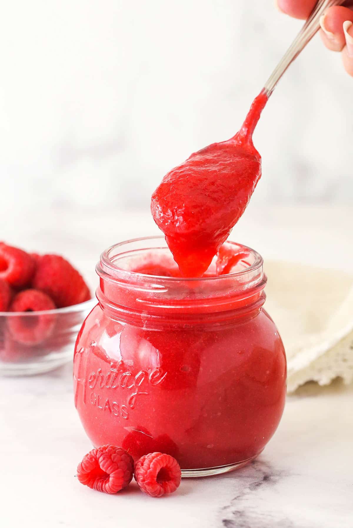 Raspberry filling for cake in a glass jar.