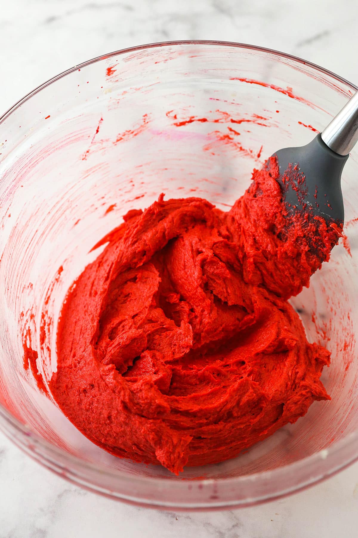 Creamed butter mixture with red food coloring.