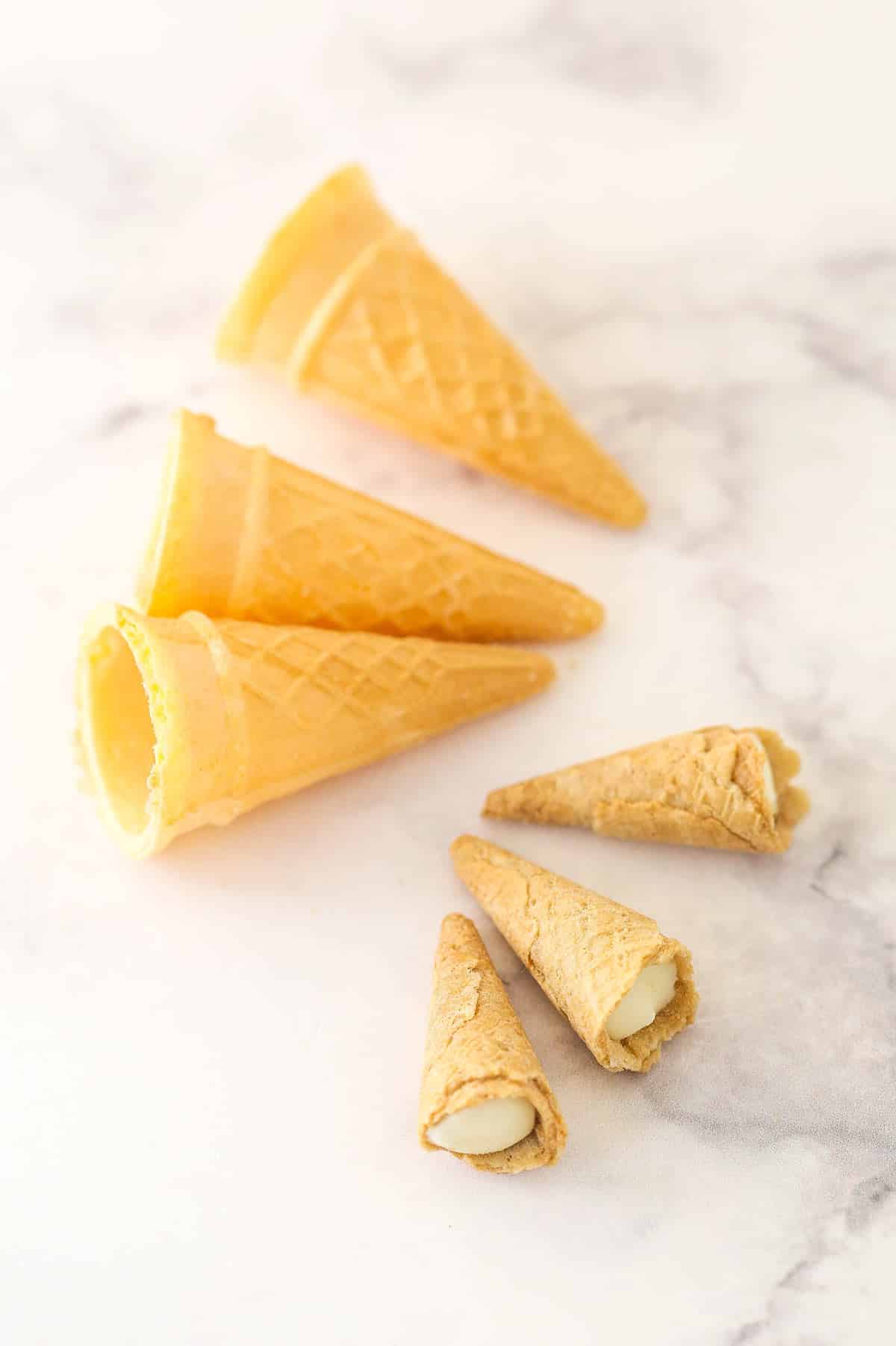 Three Muddy Buddies next to three mini ice cream cones as a comparison photo.