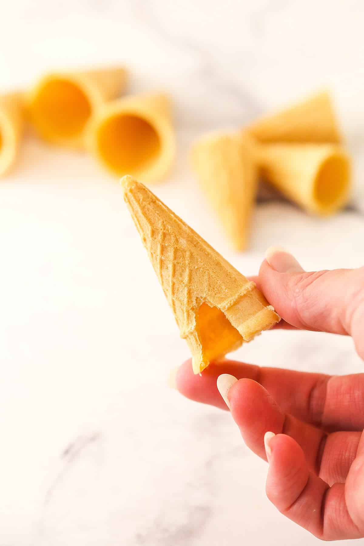 Carefully snipping a piece off the mini ice cream cone.