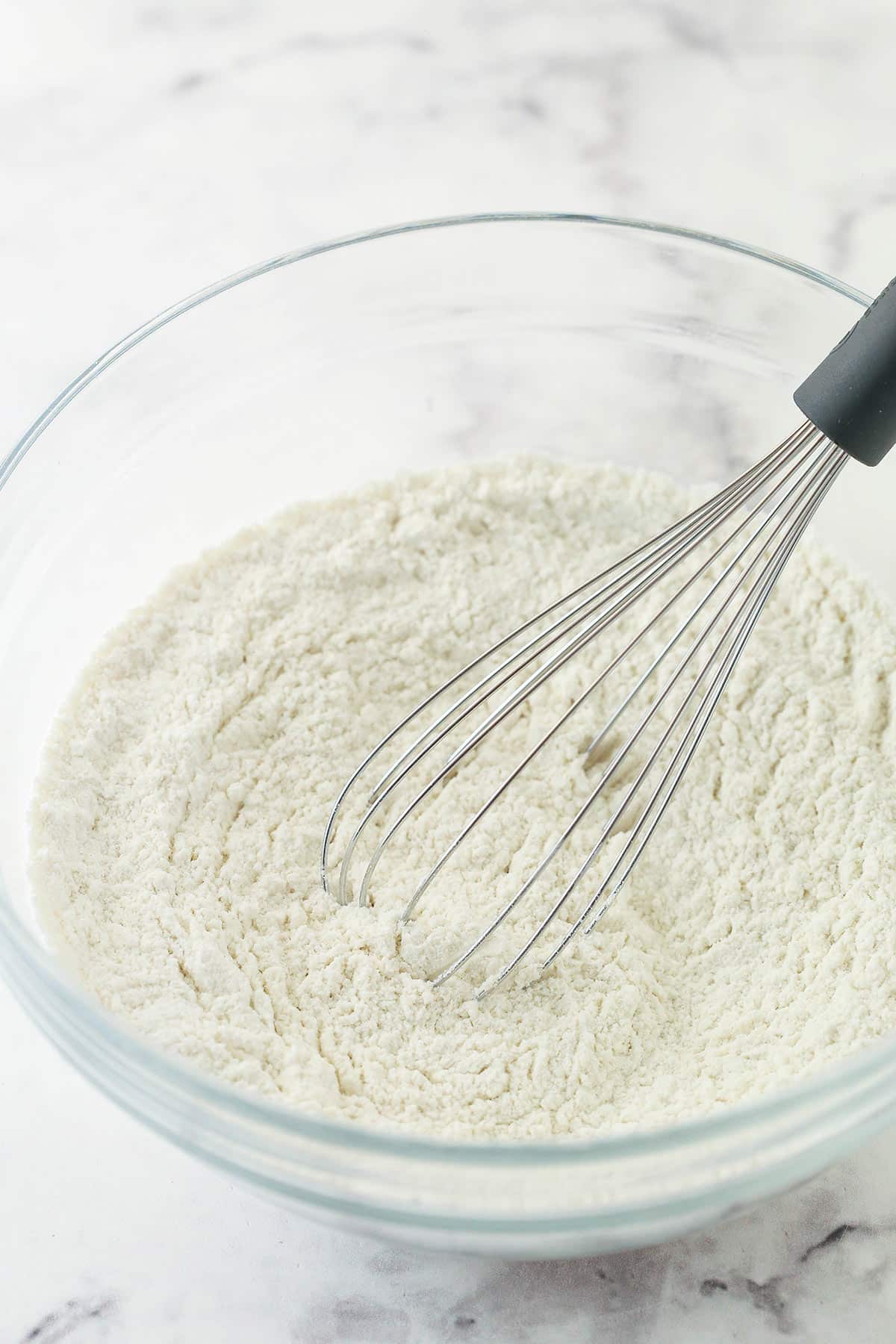 Mixing dry ingredients for conversation heart cupcakes.