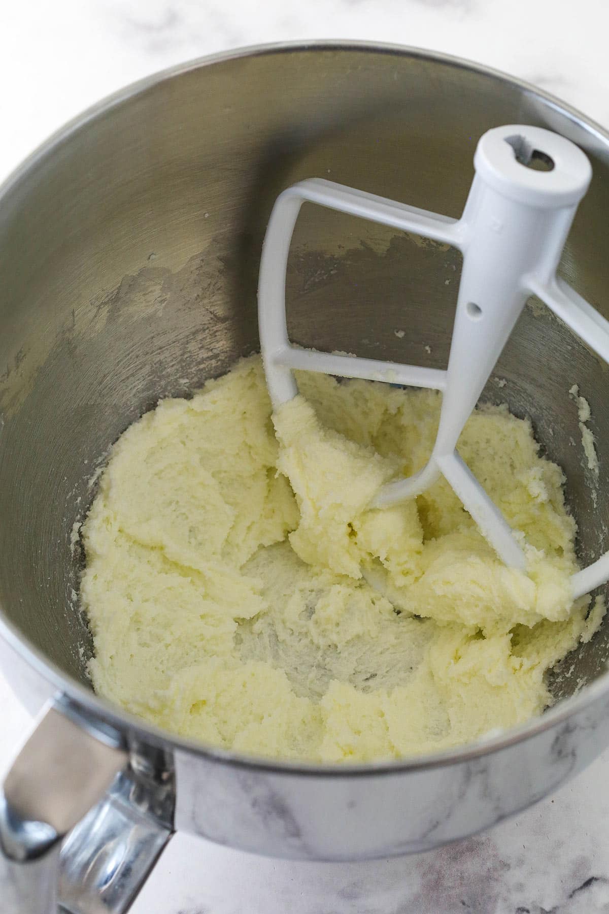 Creaming butter and sugar together for conversation heart cupcakes.