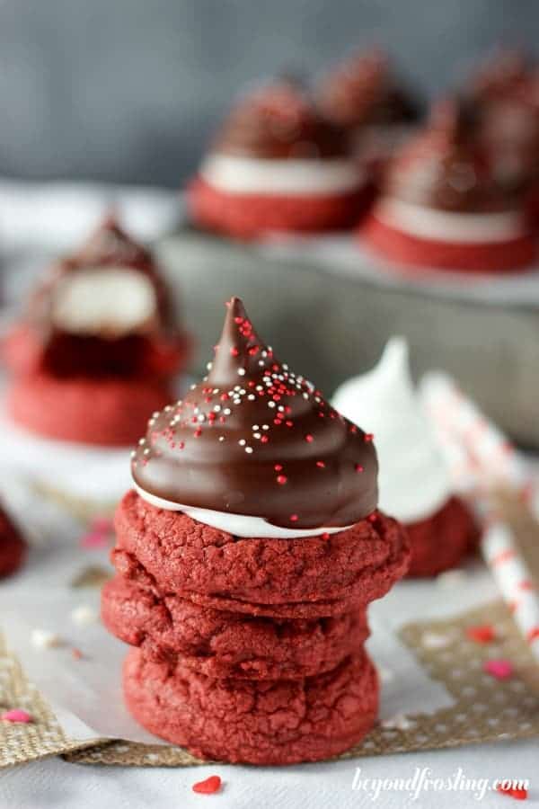 A stack of three red velvet cookies with a hi-hat marshmallow topping.