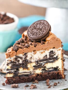A slice of ultimate Oreo cheesecake on a plate.