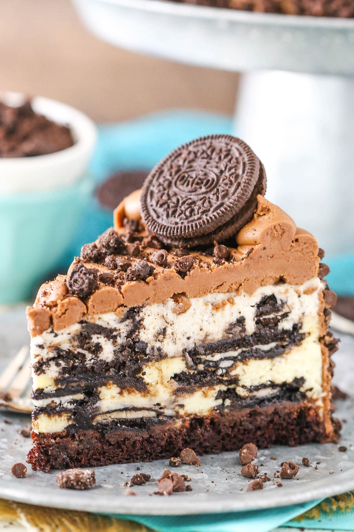 Layers of Oreo-laden components come together to make a decadent dessert that will blow your mind in this ultimate Oreo cheesecake. A slice of ultimate Oreo cheesecake on a plate.