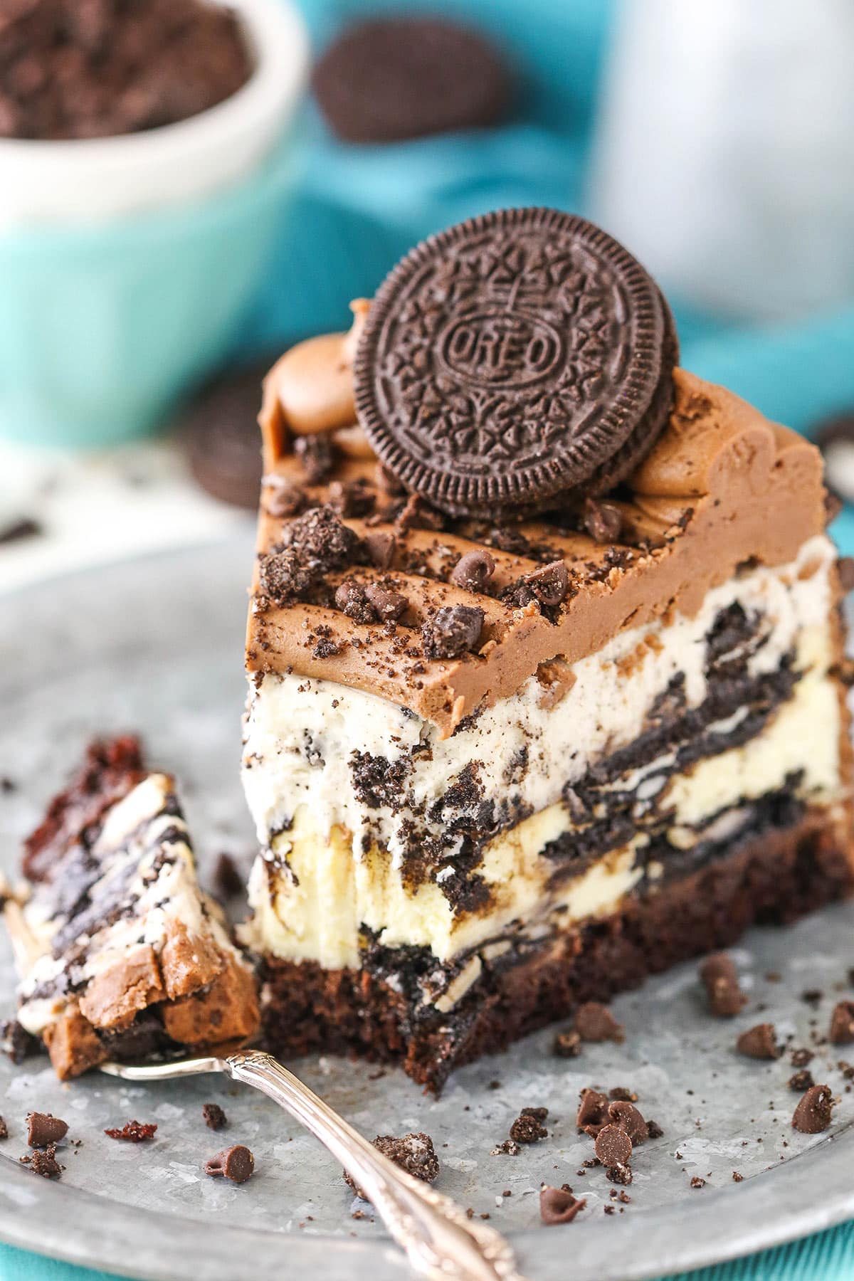 Ultimate Oreo cheesecake on a plate with a fork taking a piece out of it.