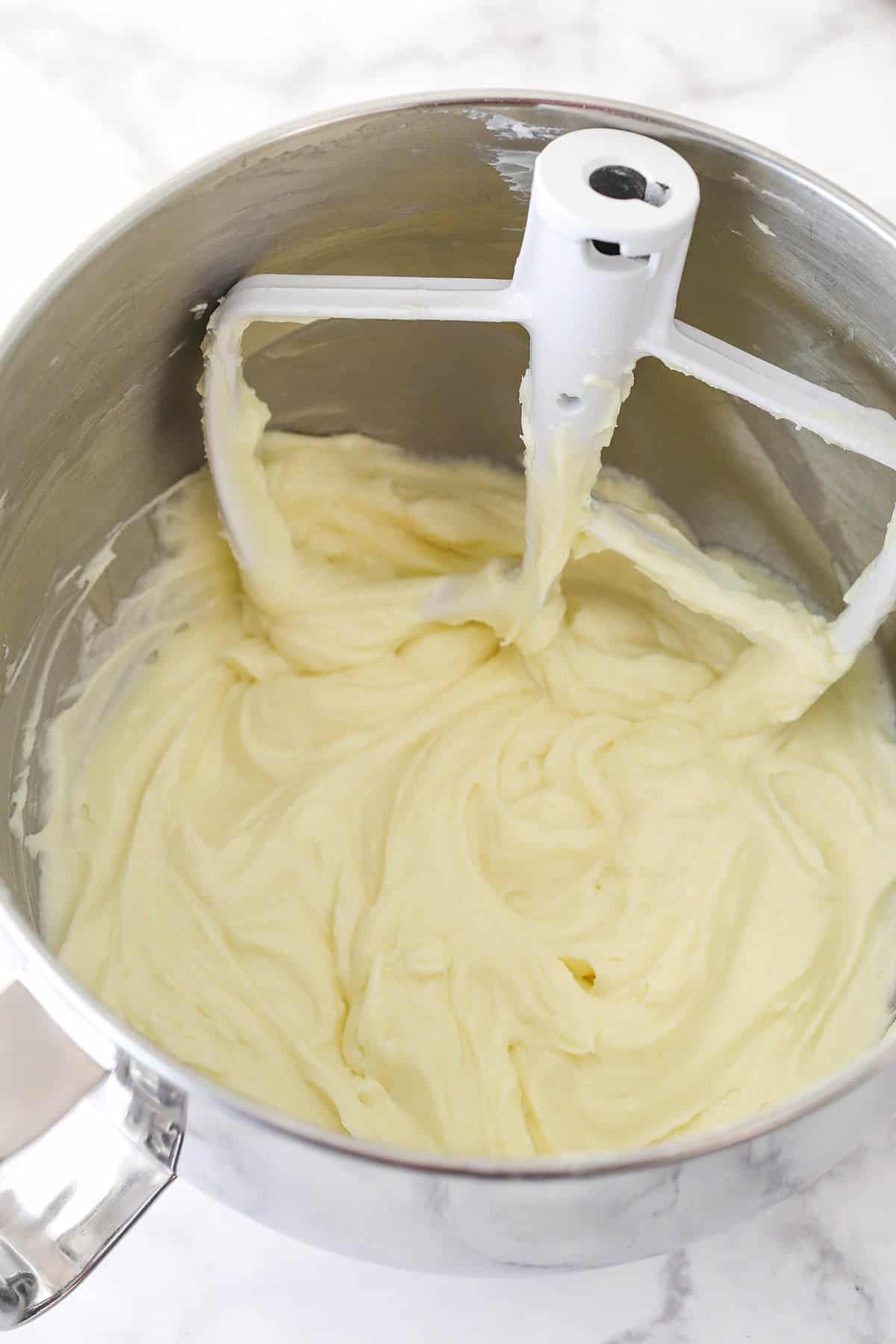 Beating cream cheese for cheesecake filling.