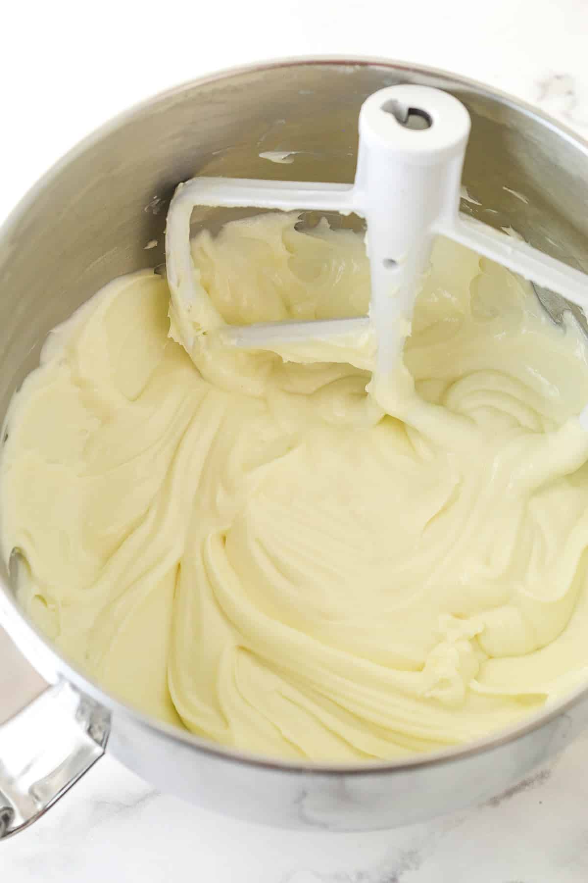Mixing sour cream into cream cheese filling.