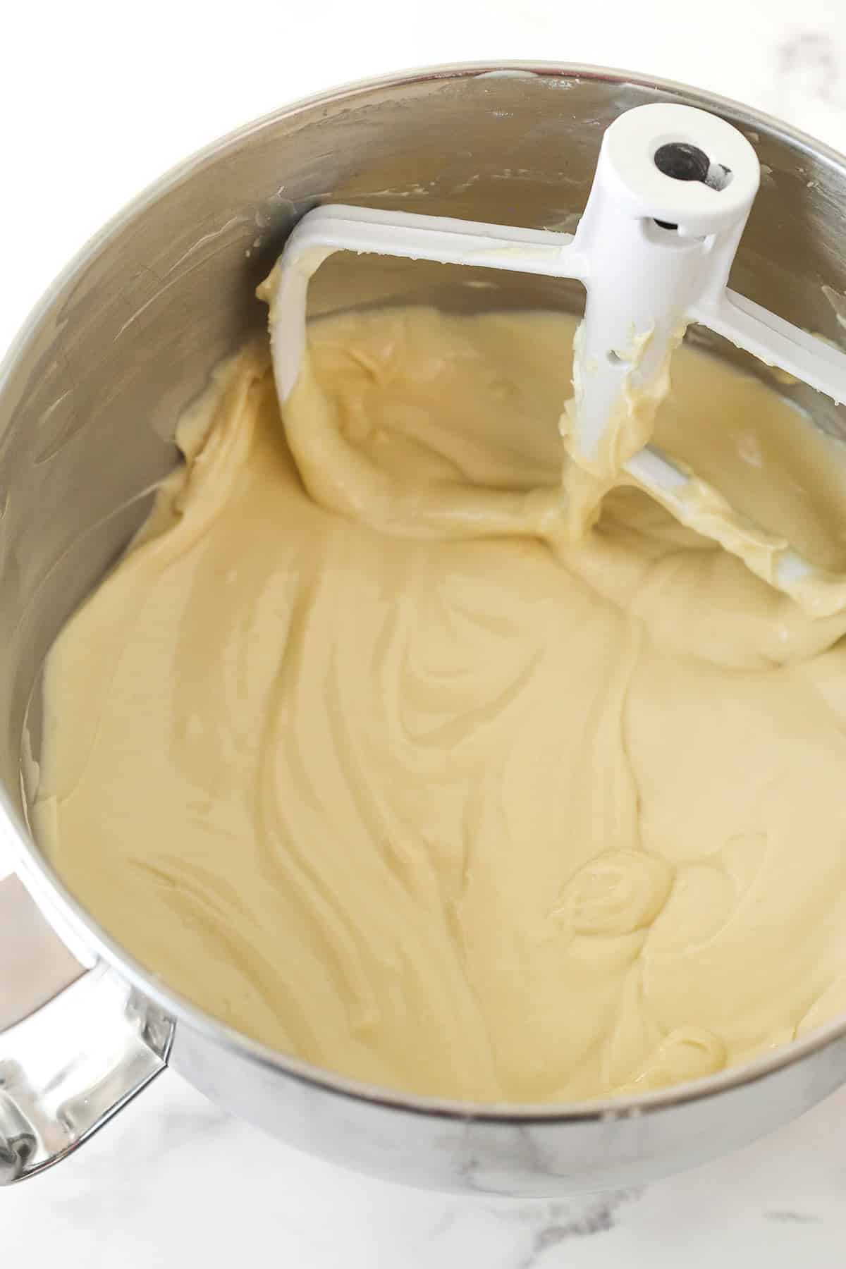 Mixing Baileys and vanilla extract into cream cheese filling.