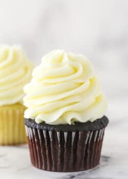 cream cheese frosting piped onto chocolate cupcake