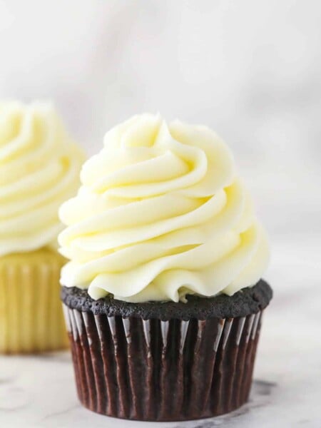 cream cheese frosting piped onto chocolate cupcake