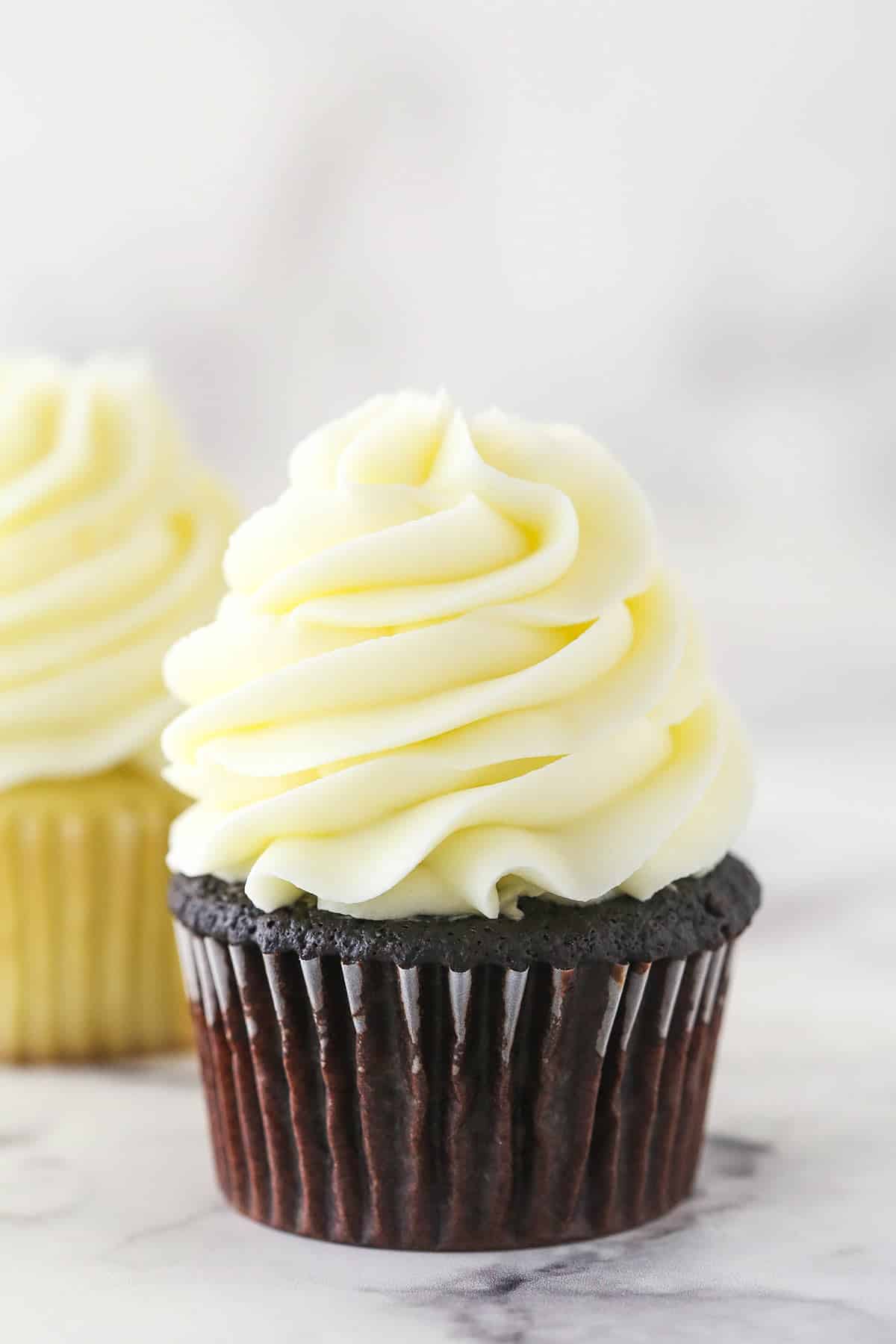 cream cheese frosting piped onto chocolate cupcake