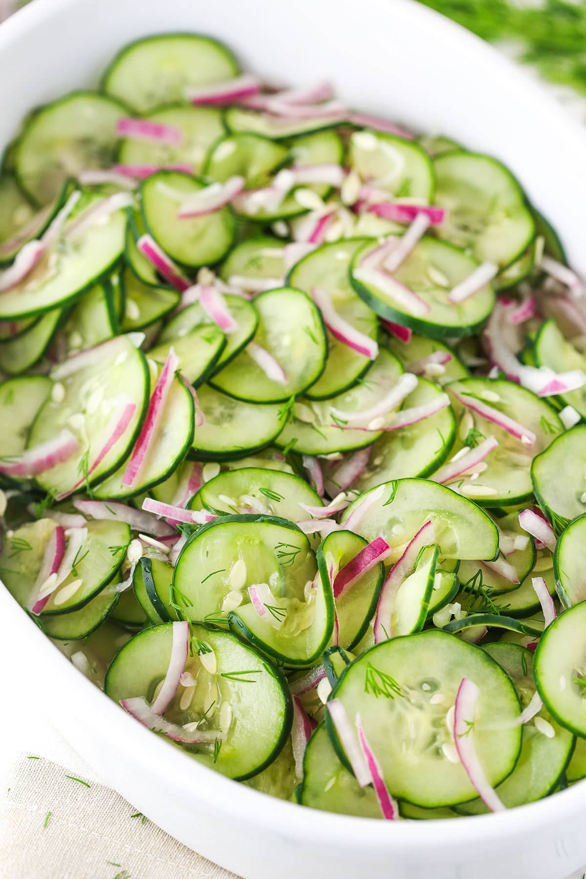 cucumber salad in white dish - angled shot