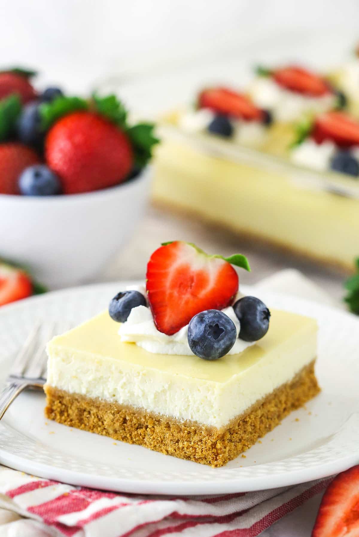 A slice of hassle free, easy cheesecake on a plate with a fork.