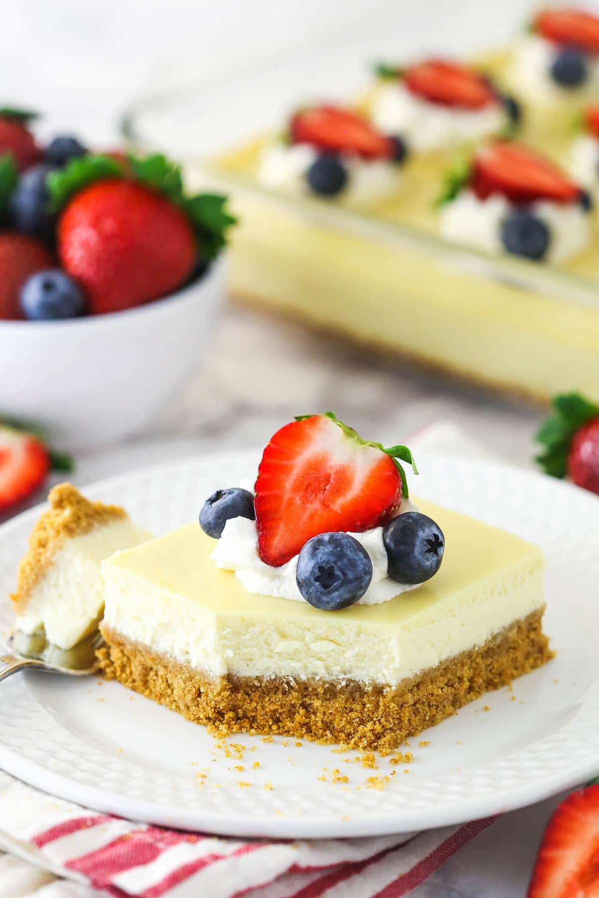 Easy cheesecake on a plate with a bite taken out of it.