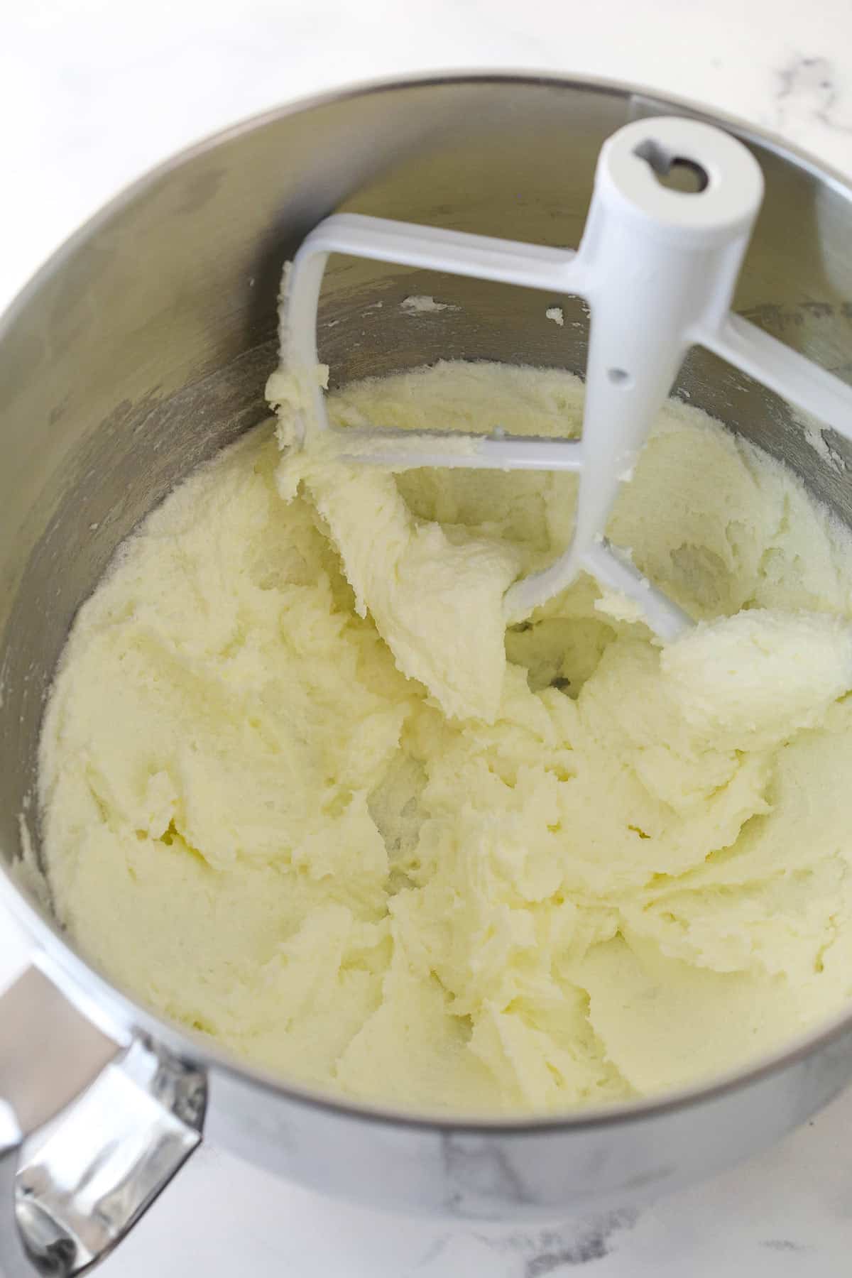 Beating together butter and sugar for cookie dough.