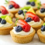 Easy fruit cheesecake sugar cookie cups arranged on a cake platter.