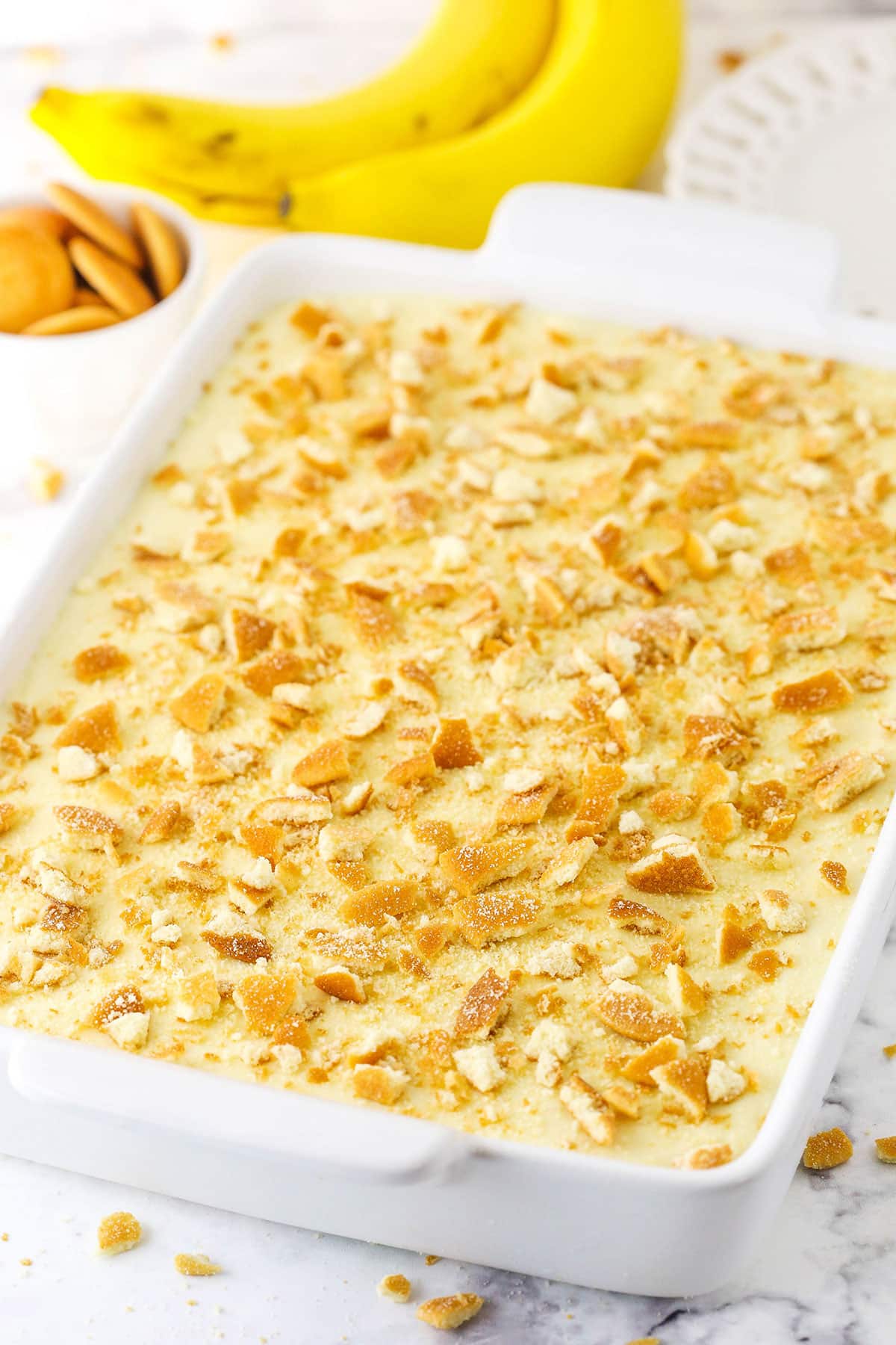 Homemade Banana Pudding topped with crushed vanilla wafers in a white platter