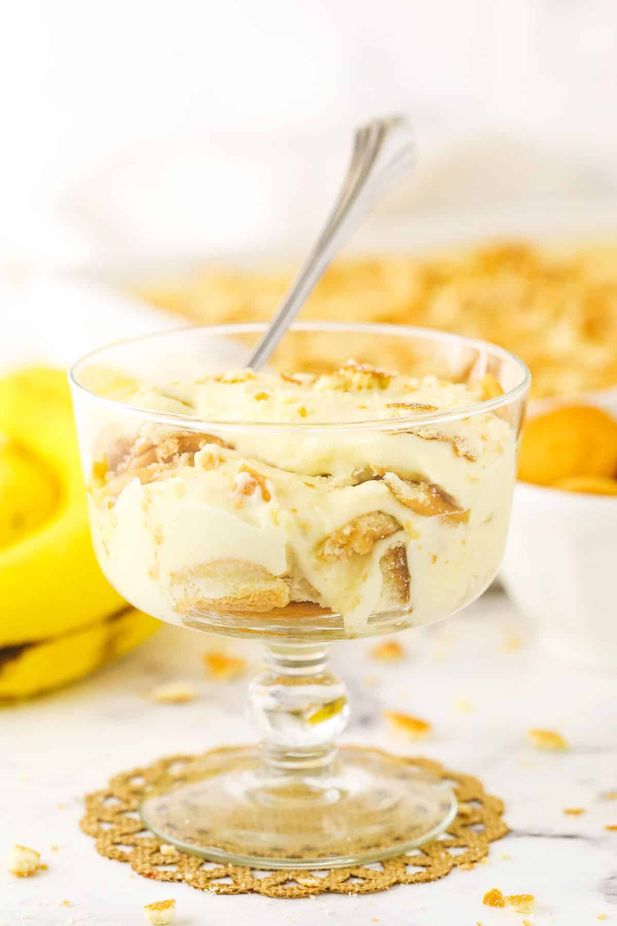 A single serving of Homemade Banana Pudding in a glass bowl with a spoon