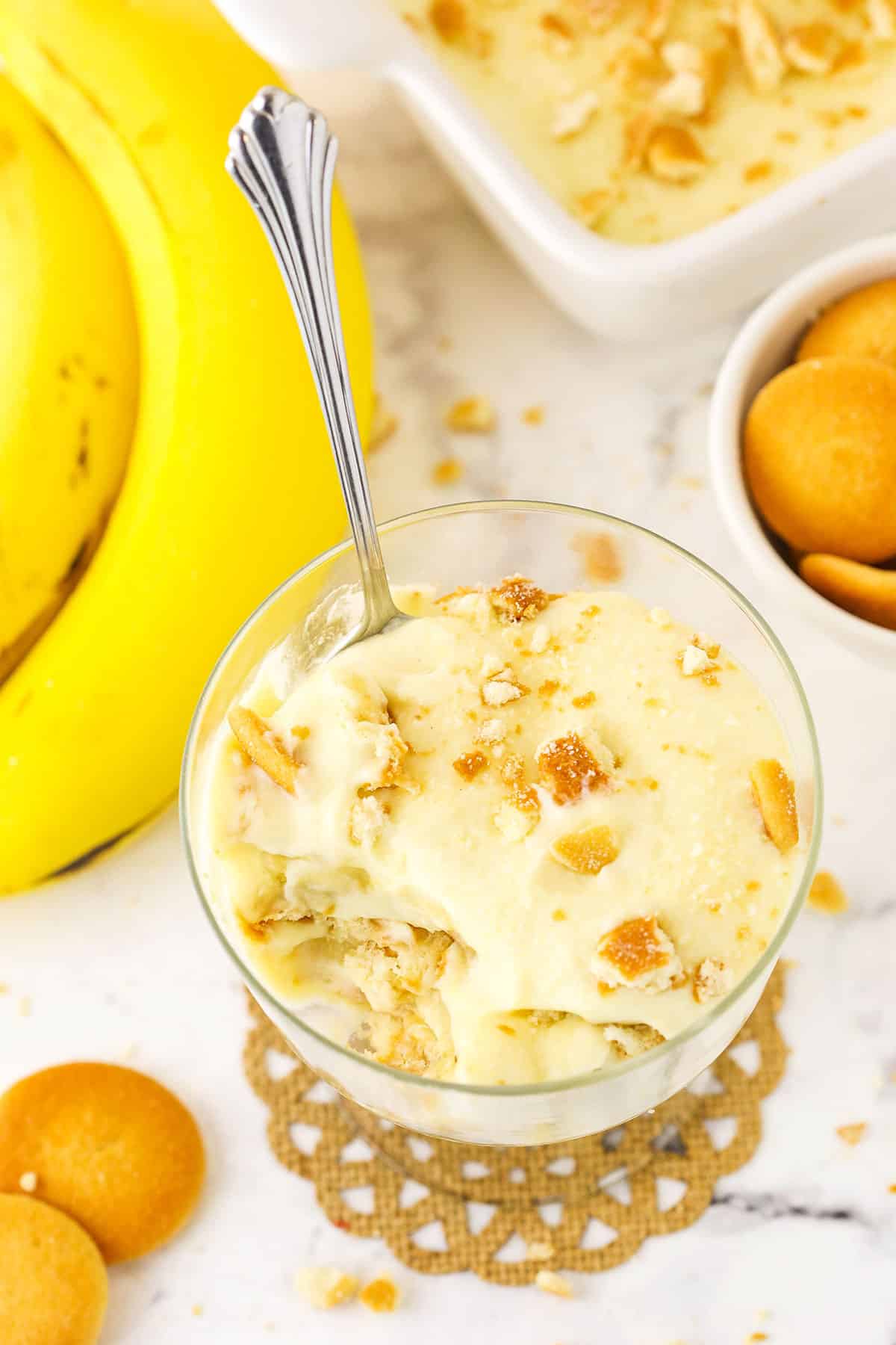 A single serving of Homemade Banana Pudding in a glass bowl with a spoon