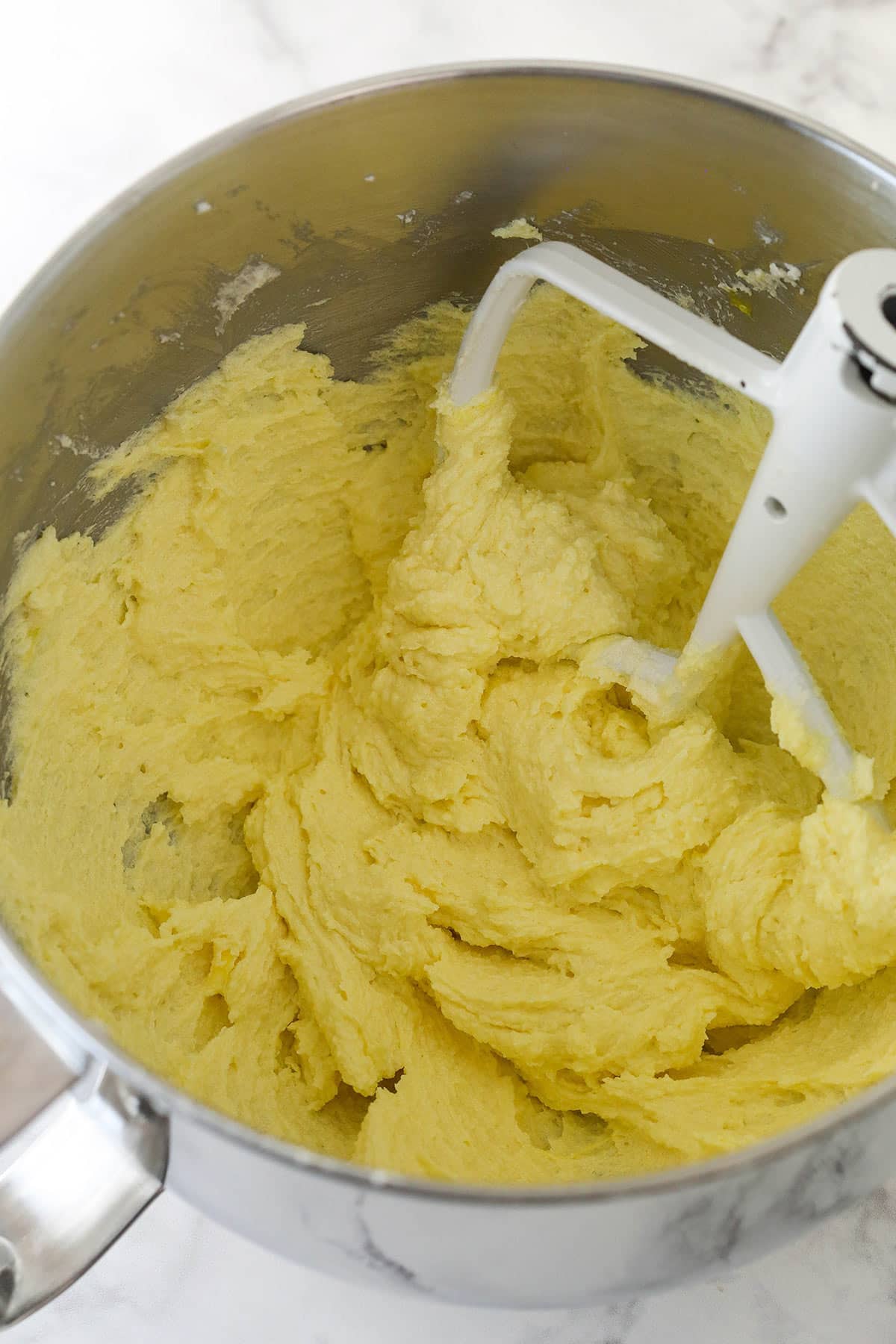 Adding egg yolks to cake batter.