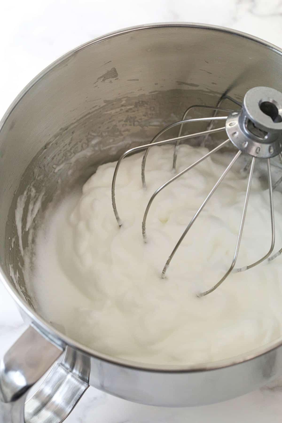 Whipping egg whites in a mixing bowl.