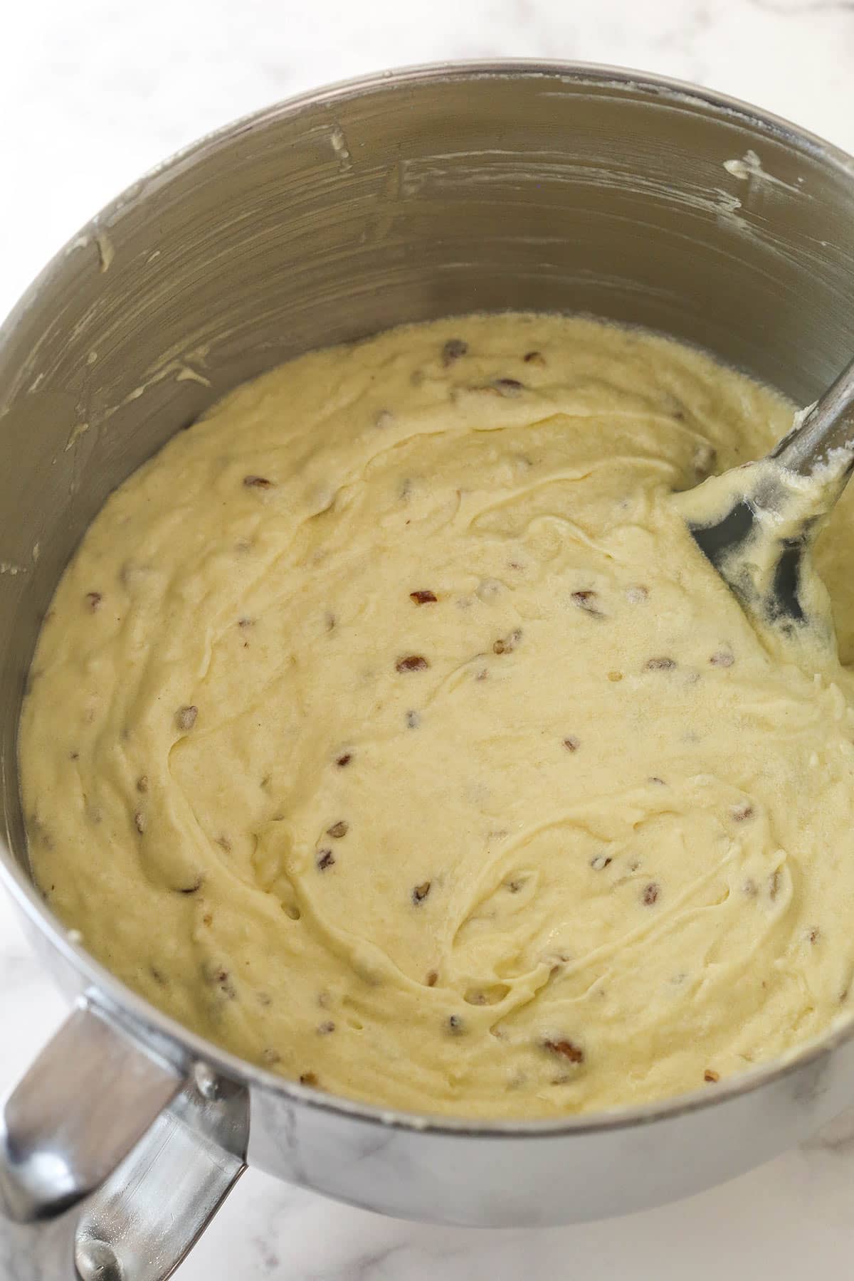 Adding toasted pecans and coconut to cake batter.