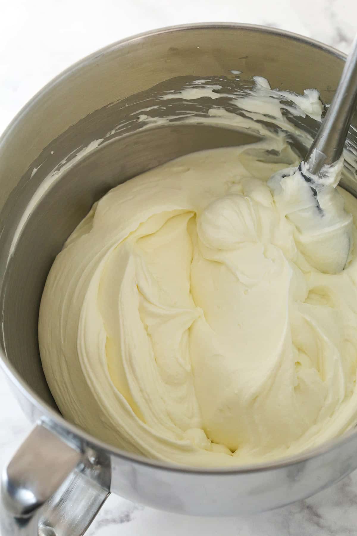 Making whipped cream cheese frosting.