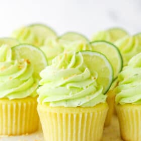Closeup image of key lime coconut cupcakes on a cake stand.