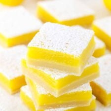 A stack of lemon bars dusted with powdered sugar.