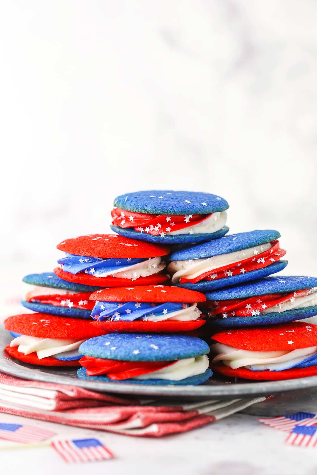 cookie sandwiches stacked on a silver plate