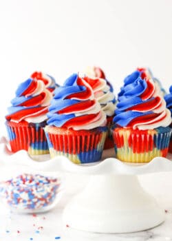 close up of red, white and blue cupcakes on a cake stand