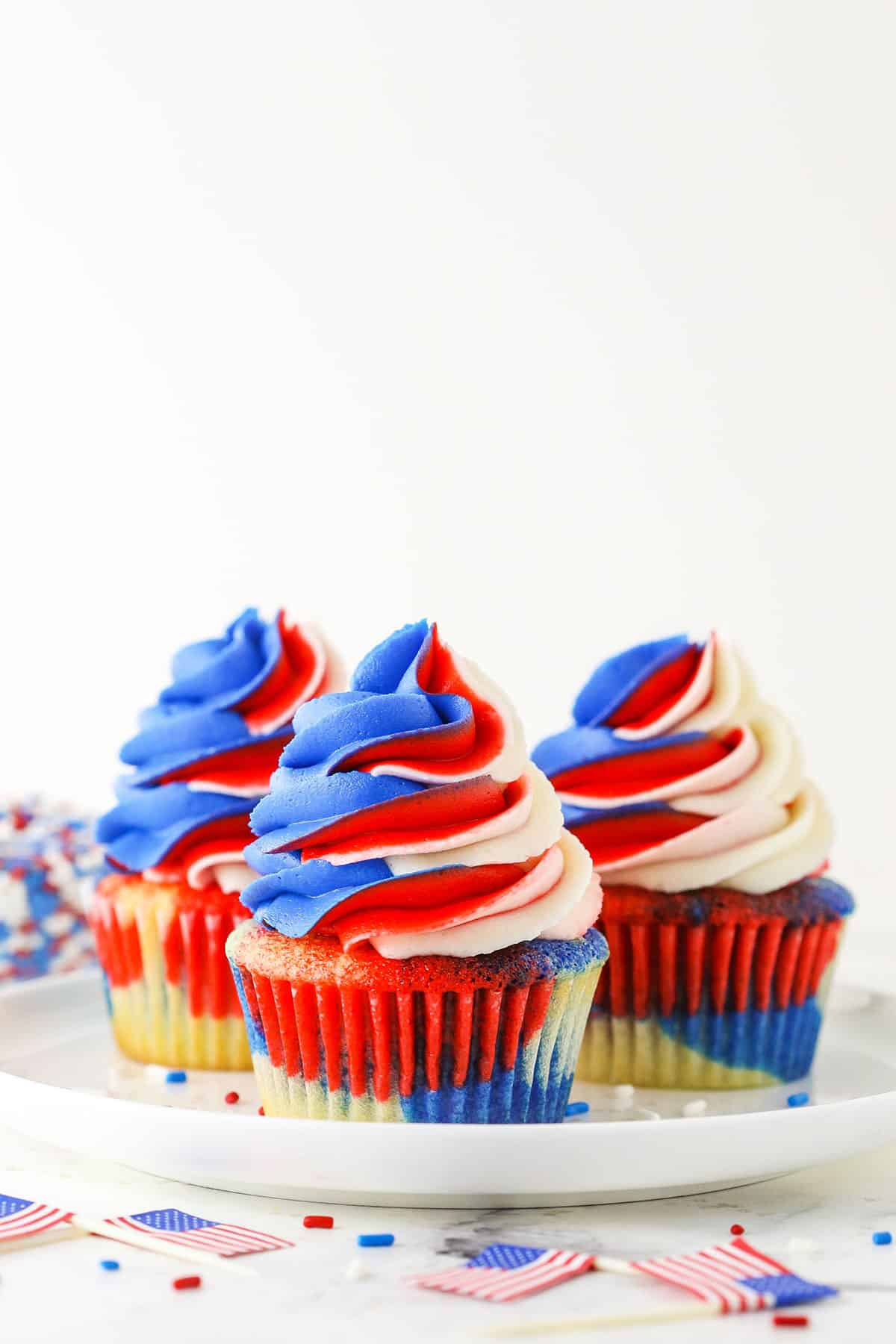 red, white and blue cupcakes on white plate