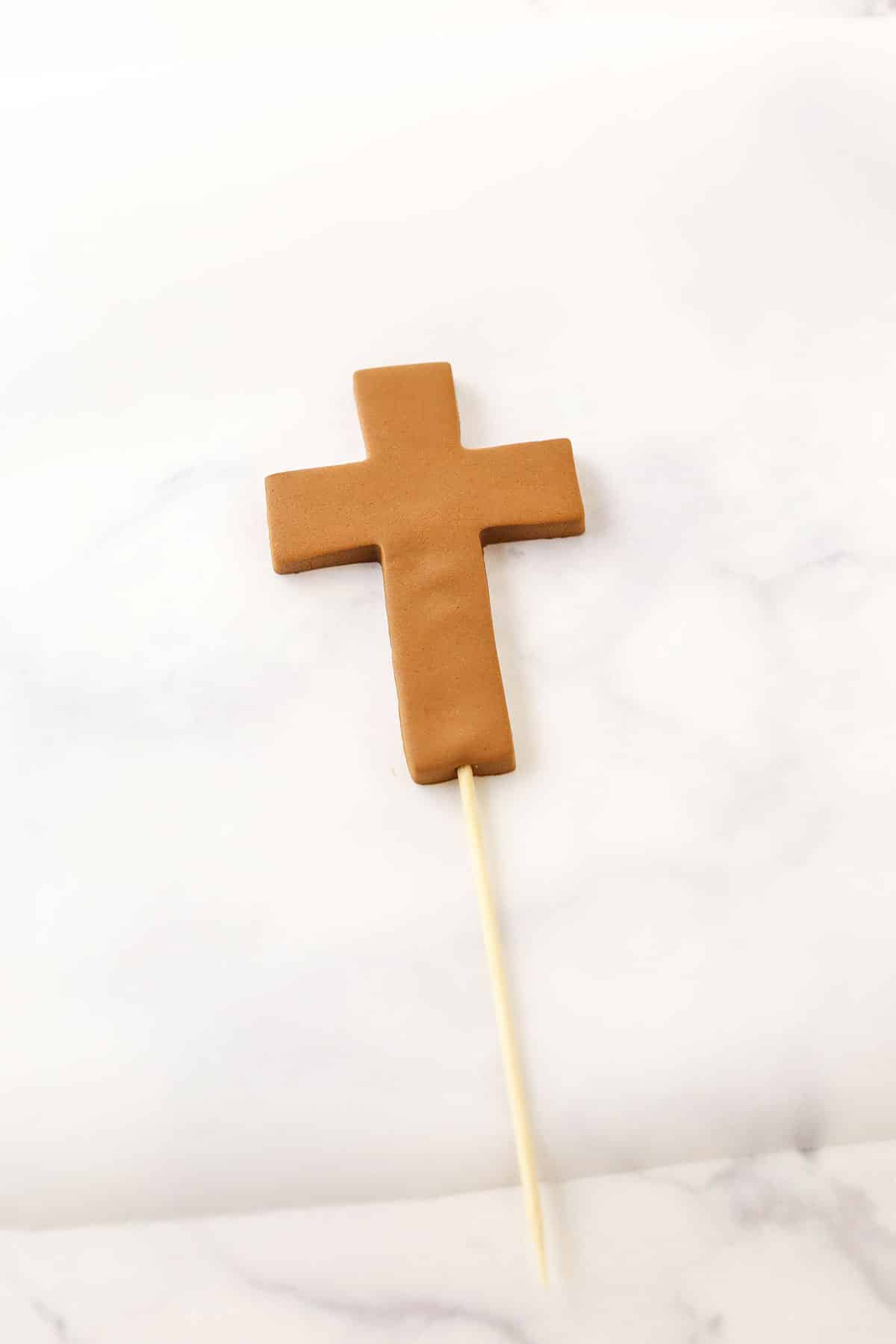 A step in making a Resurrection Cake showing the skewer inserted into the bottom of the cross