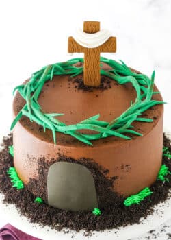 Side view of a Resurrection Cake decorated with a fondant cross and crown of thorns