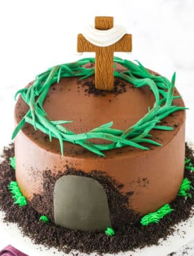 Side view of a Resurrection Cake decorated with a fondant cross and crown of thorns