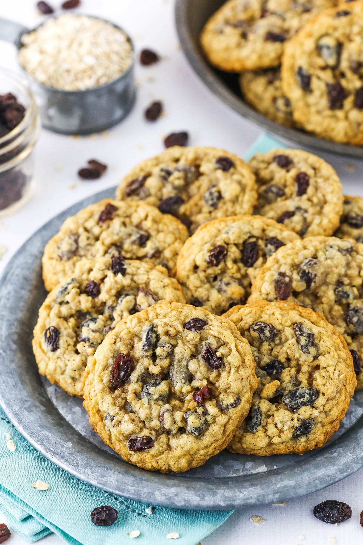 Side view of a grey plate full of the best oatmeal raisin cookies.