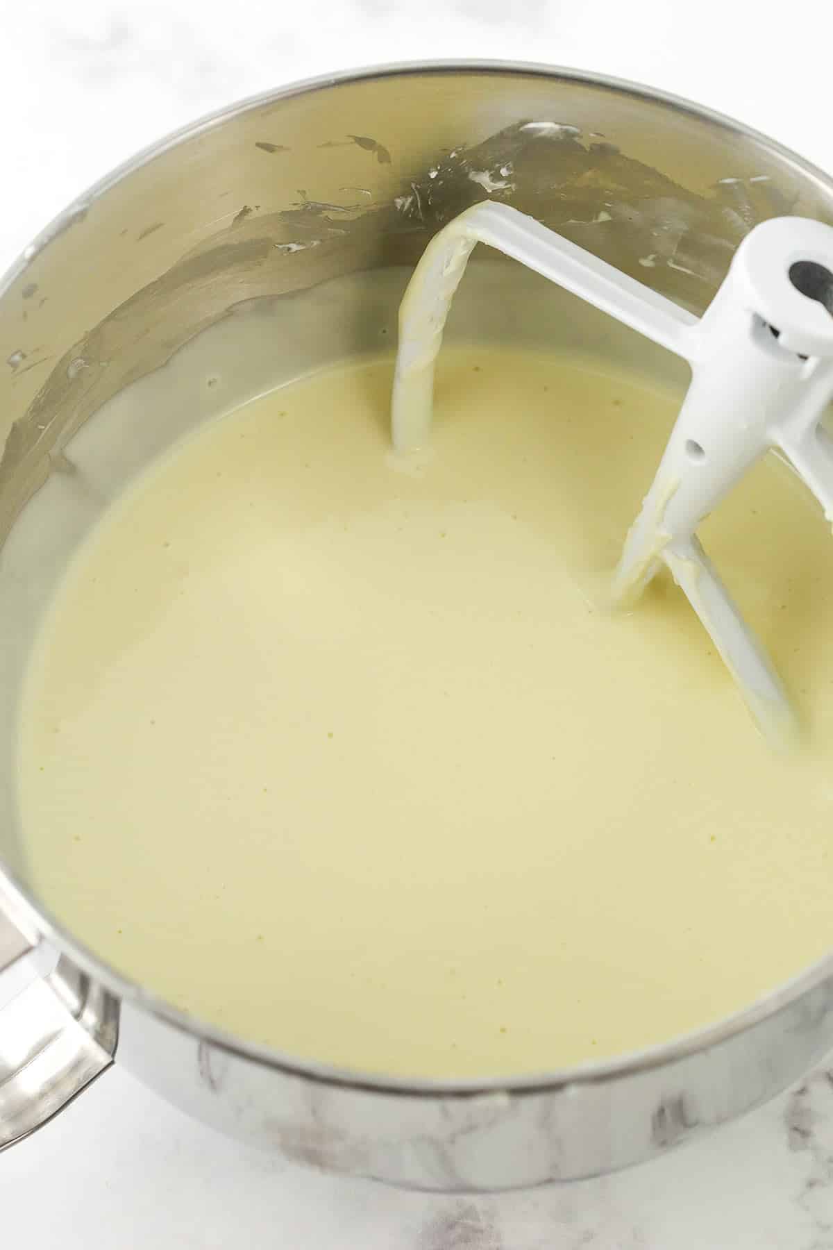 Vanilla cheesecake batter in a mixing bowl.